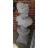 A concrete garden bust of lady on circular pillar
