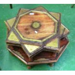 A low eastern octagonal table with brass decoration and a star shaped table