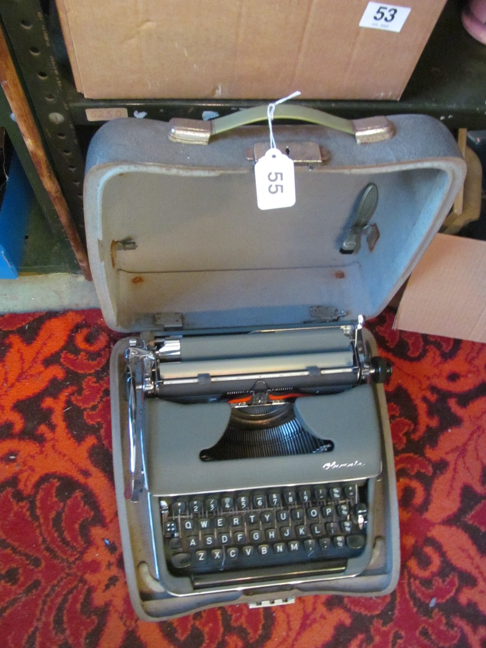 A vintage Olympia typewriter in grey case