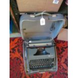 A vintage Olympia typewriter in grey case