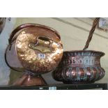 A copper coal bin and copper circular log holder