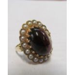 A 9ct gold cluster ring with red stone and pearls