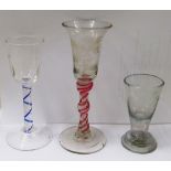 Two coloured stem glasses and an engraved glass
