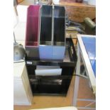 A black perspex three tier trolley/table, three filing boxes and a desk light