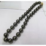 A grey bead necklace with 14k gold clasp