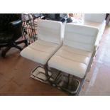 A pair of cream bar chairs