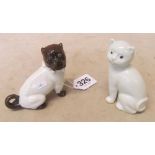 A china model of a Pug dog and a white china cat