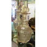 A 19th Century cut glass decanter with three ring neck and spire style stopper (chips to rim and