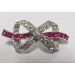 A diamond and ruby bow brooch 6.2gms