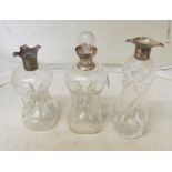 Three dimple decanters with silver collars (two without stoppers)