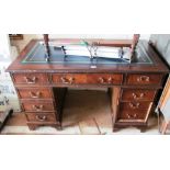 A reproduction nine drawer twin pedestal desk with leather inset top