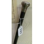 A cane with silver top