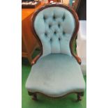 A blue button upholstered showframe Victorian chair