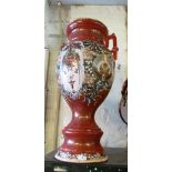 A Japanese tall two handled vase iron red ground and wing style pattern
