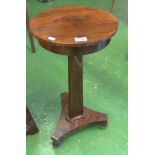 A small circular top occasional table