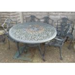 A black circular pierced design garden table and five chairs