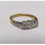An 18ct gold and platinum three stone diamond ring 3g, size M
