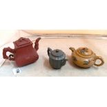 A Yixing teapot bamboo and prunus design, green fluted teapot and two colour teapot (cracked)