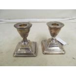 A silver topped jar and pair silver dwarf candlesticks