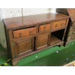 An 18th Century oak dresser base three drawers and three cupboards (one loose and water damage)