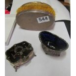 A silver and tortoiseshell lidded ring box, two silver backed brushes and a silver salt