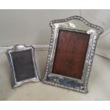 A silver photo frame and smaller frame, wooden back