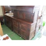 A 17th Century style carved oak court cupboard (water damage)
