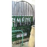 A wrought iron garden gate with accessories