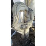 A fibreglass stone effect garden statue girl with long hair with head bent seated on a column