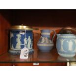 A Wedgwood blue Jasper biscuit barrel and two jugs