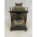 An ebonized Victorian bracket clock with gilt pierced floral dame top, brass chapter ring eight