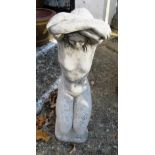 A fibreglass stone effect garden statue kneeling woman