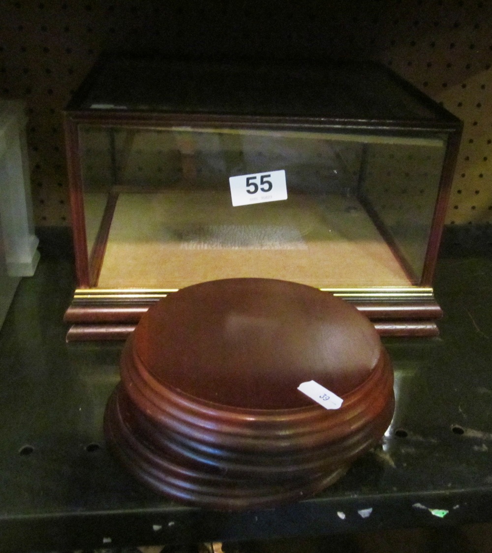 A display case and three treen stands