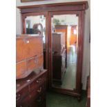 A mahogany double wardrobe with mirror doors Powell & Powell