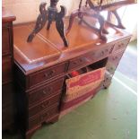 A reproduction twin pedestal desk with leather inset top