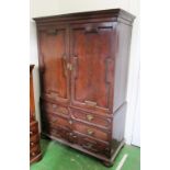 An antique oak ex-linen press with two panelled doors and hanging rail and two short and two long