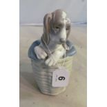 A Lladro model of dog in basket