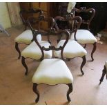 A set of five Victorian semi-balloon back dining chairs with carved backs and another