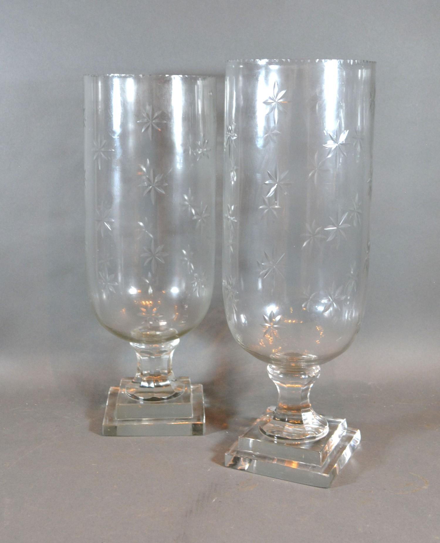 A Pair of Cut Glass Storm Lamps with star cut decoration, 40 cms tall