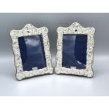 A Pair of London Silver Photograph Frames of Embossed Form, 19 x 14 cms