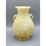 A Chinese Jade Vase carved with two reserves amongst bamboo and with foe head side handles, 19 cms