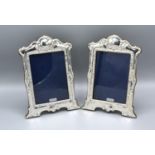 A Pair of London Silver Photograph Frames of Shaped Embossed Form, 21 x 15 cms