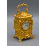 A Brass Cased Carriage Clock of Rococo Form with circular enamel dial 7cms tall