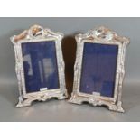 A Pair of Sterling Silver Photograph Frames, each of shaped and embossed form 21.5cm by 15cm