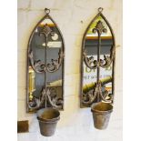 A Pair of Weathered Metal Wall Mirrors of shaped form each with a single planted 64cm by 20cm