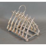 A Silver plated Six Division Toast Rack in the form rifles