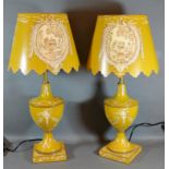 A Pair of Tollware Table Lamps and Shades with painted decoration upon a yellow ground 55cm tall