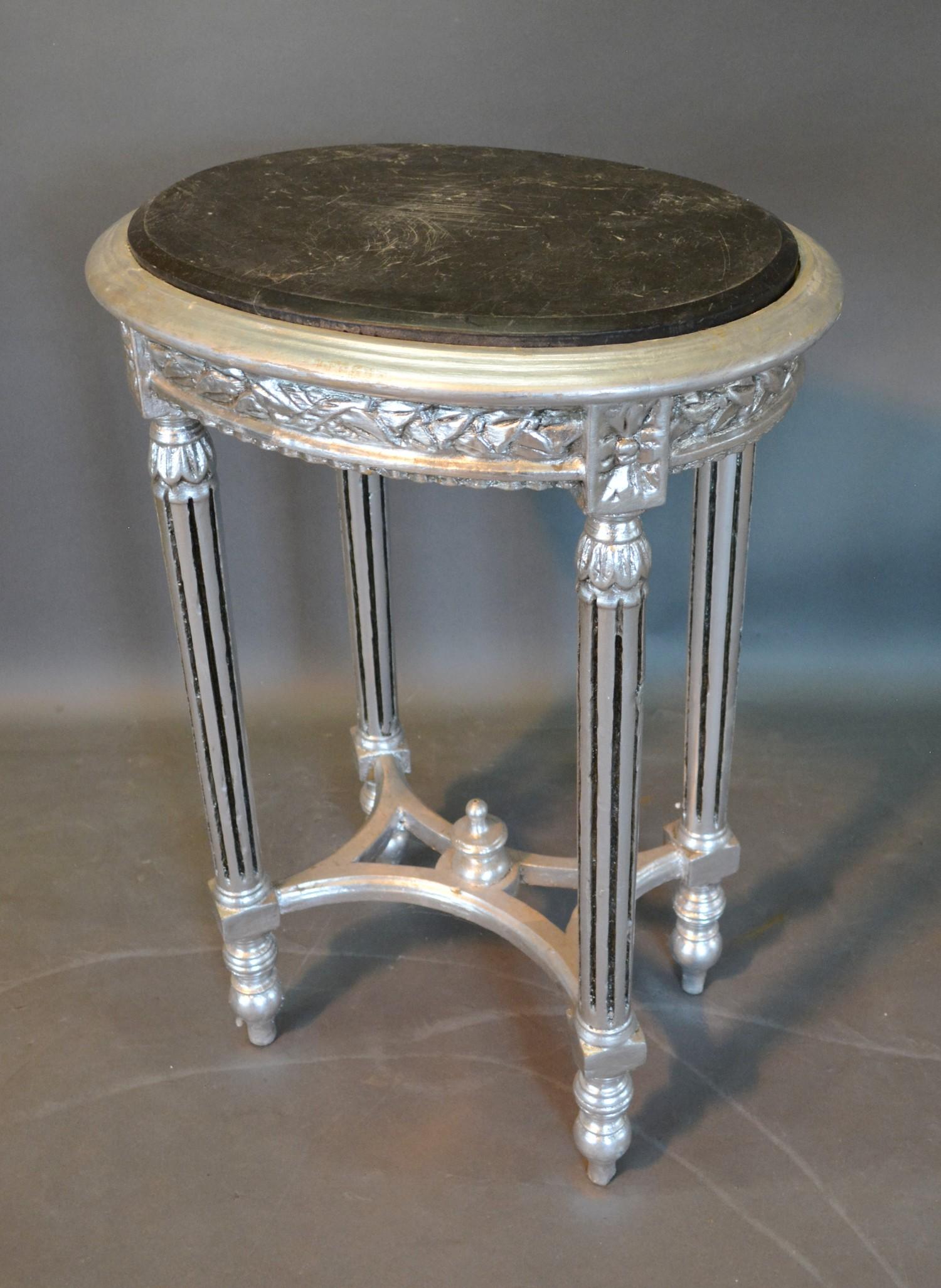 A French Style Silvered Side Table with variegated marble top above a carved frieze raised upon