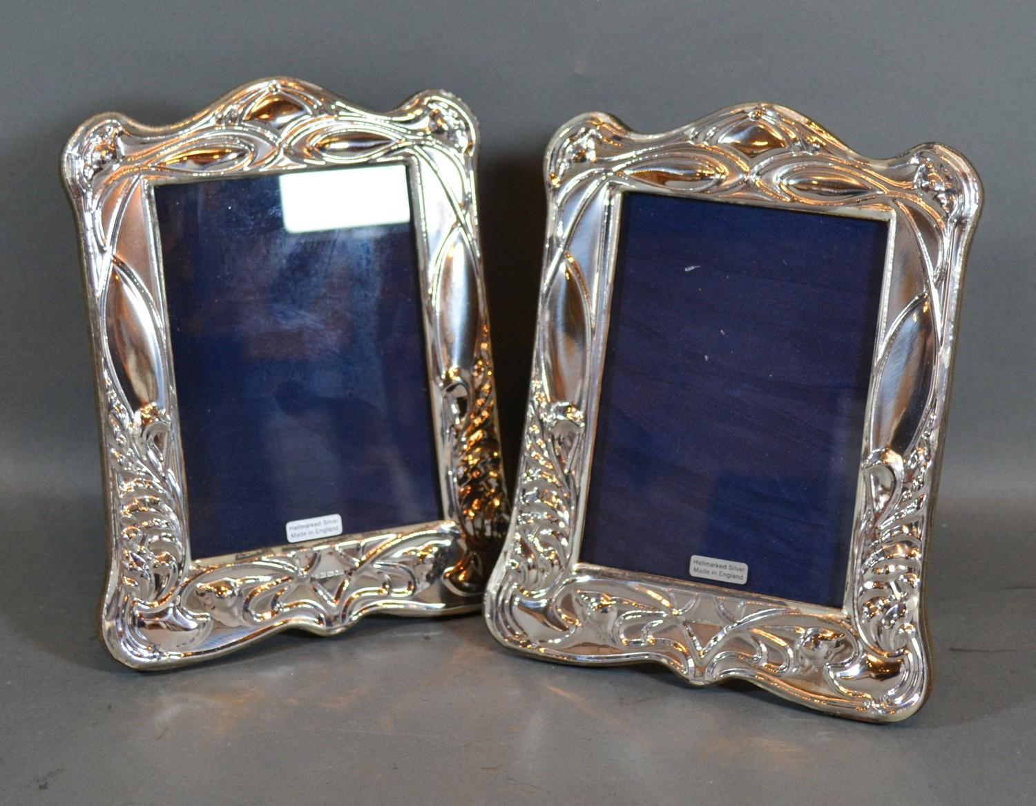 A Pair of Art Nouveau Style Sterling Silver Photograph Frames with embossed decoration 20cm by 16cm