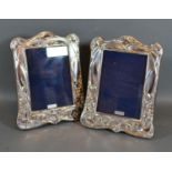 A Pair of Art Nouveau Style Sterling Silver Photograph Frames with embossed decoration 20cm by 16cm